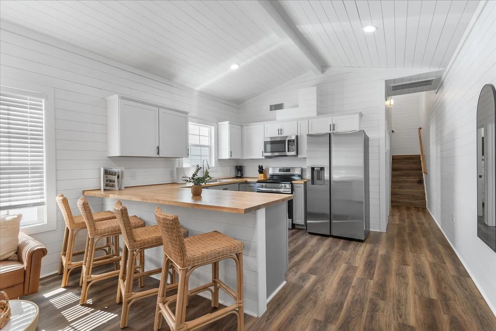 Cabin kitchen with island seating and stainless appliances