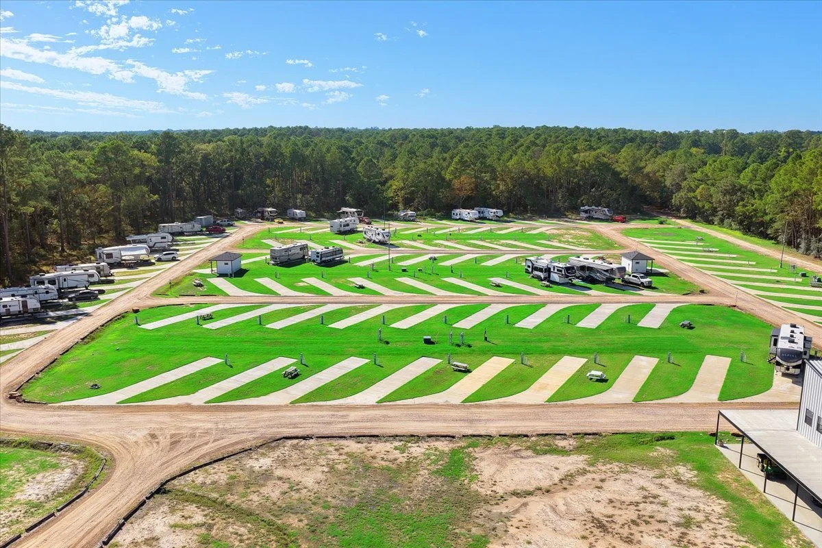 Aerial view of the resort's concrete RV pads, roads and surrounding pine forest