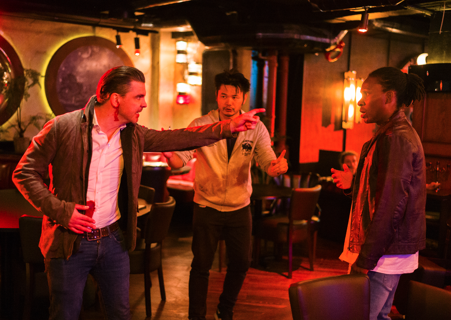Jean-Paul Ly directing a fight between two actors on set