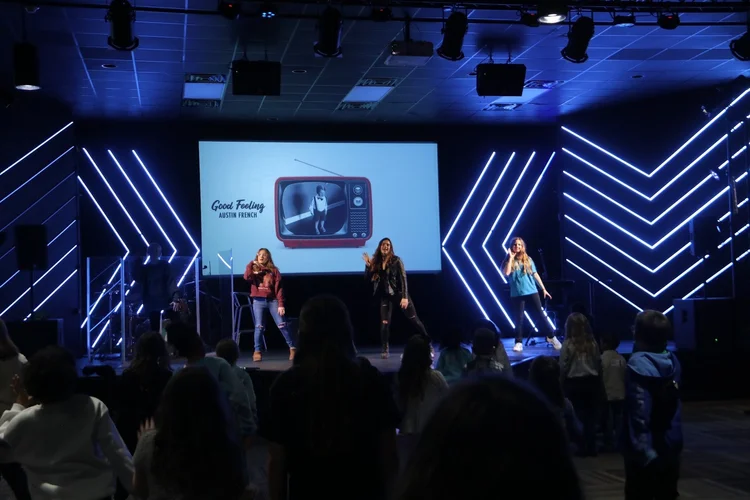 Elementary kids dancing along with leaders during worship in the Freedom Kids room