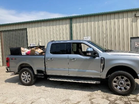 A pickup truck loaded with items being hauled away