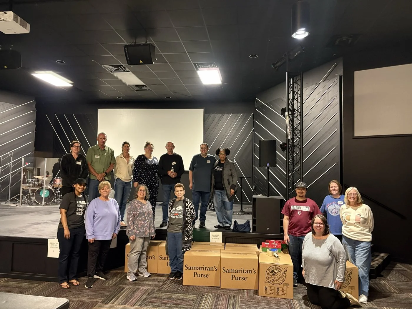 Freedom Church volunteers with boxes of Operation Christmas Child shoeboxes ready to ship