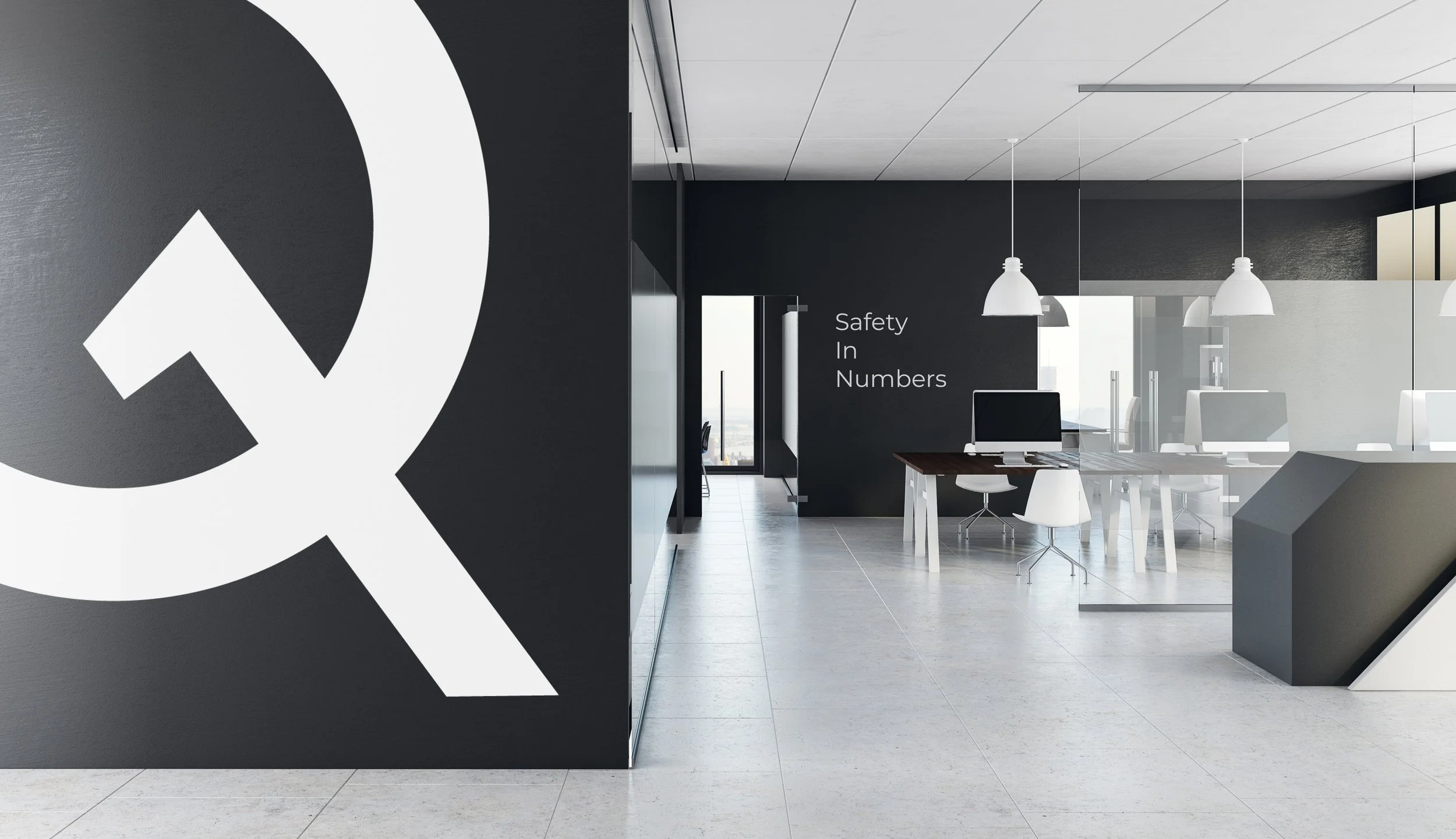 Original Quantal workplace branding with large Q symbol and Safety In Numbers signage