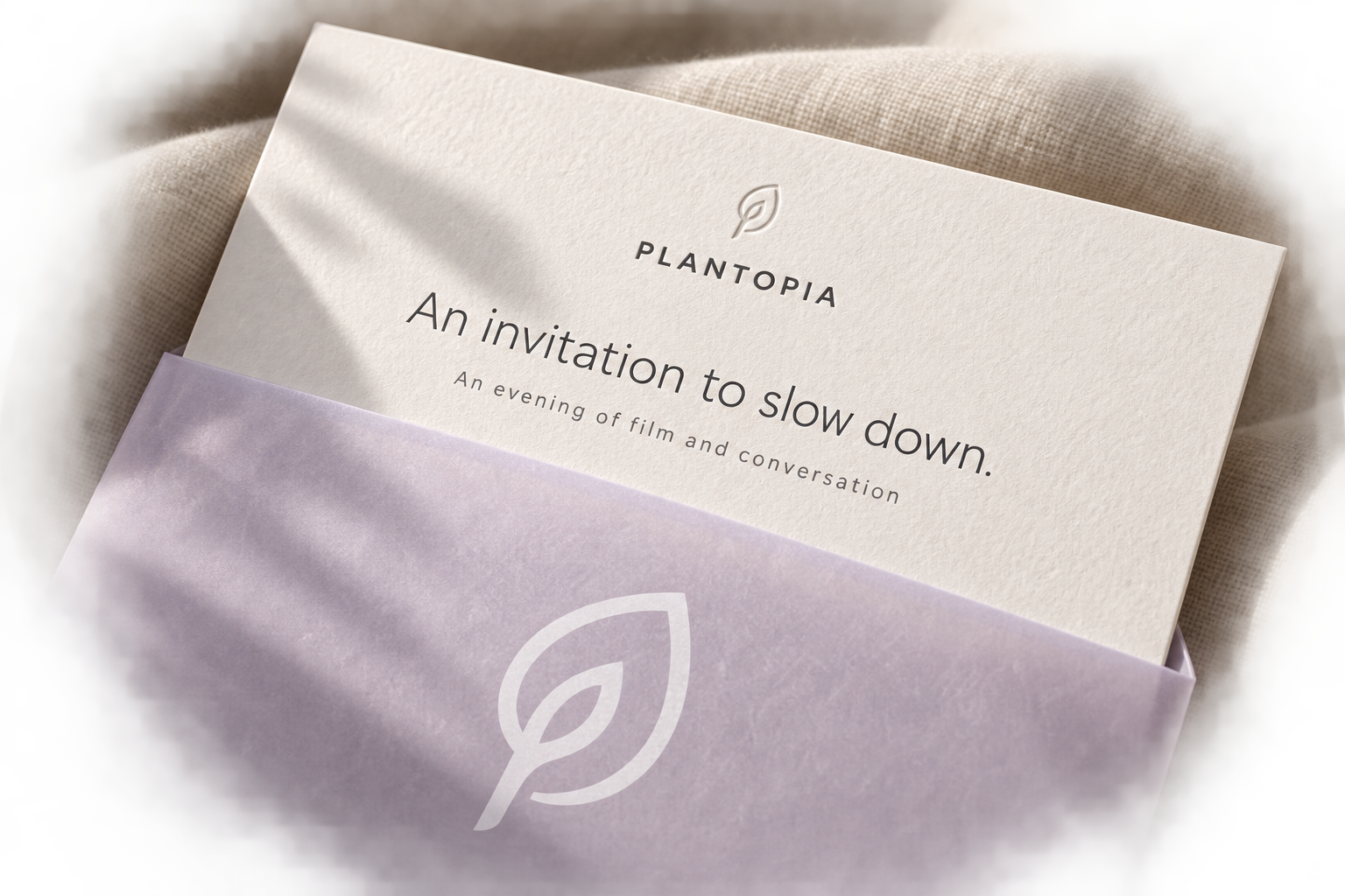 Plantopia film-event invitation concept on textured cream paper with a translucent lavender sleeve and the original leaf mark