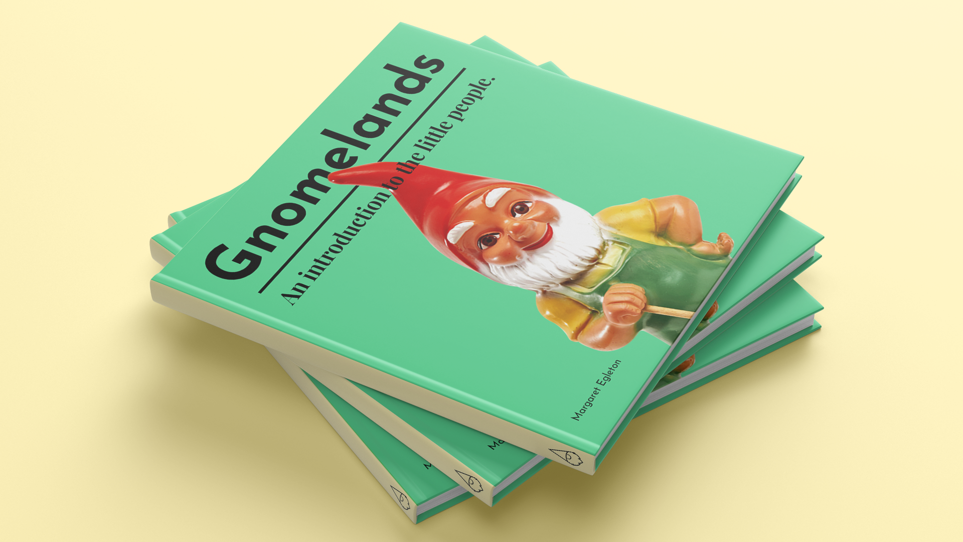 Original Gnomelands book-cover presentation showing a stack of green books with gnome photography