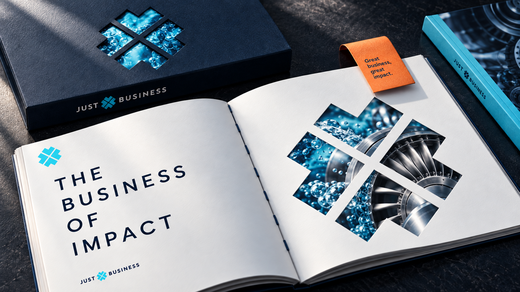 Tactile Just Business investor publication with a navy slipcase, die-cut identity windows and cyan industrial photography
