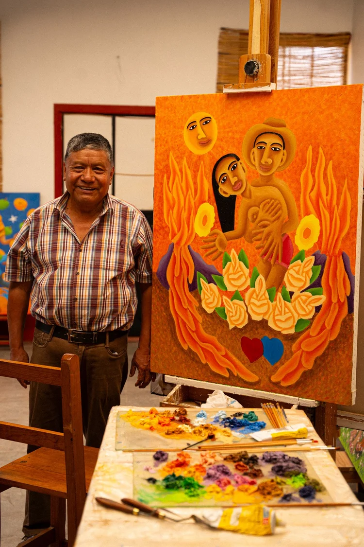 Gerardo with his painting Amor Divino in process