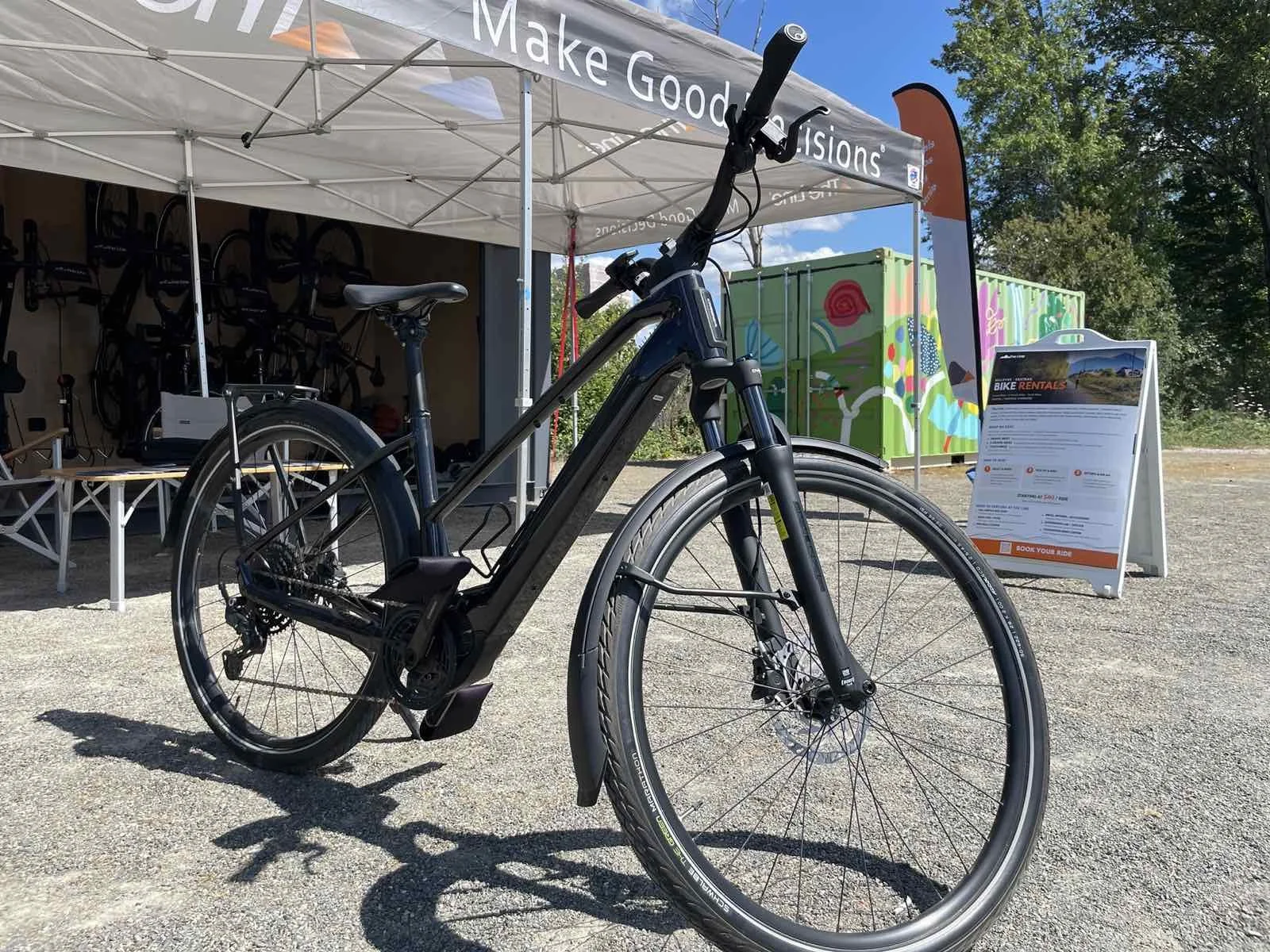 A flat bar e-bike parked and ready outside The Line kiosk on the Bellevue Eastrail
