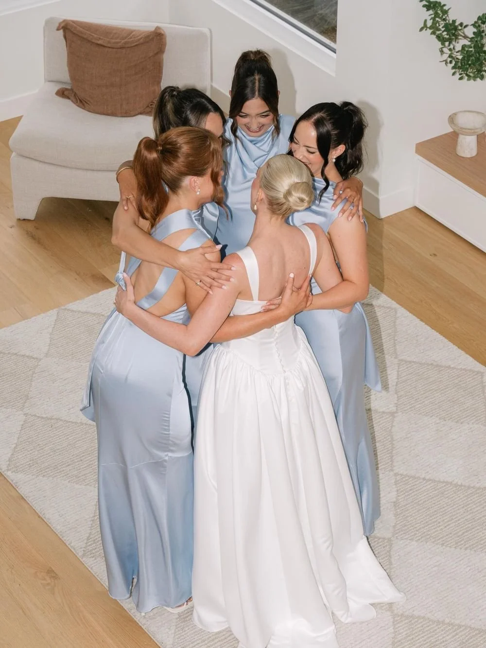 Bride hugging her bridesmaids