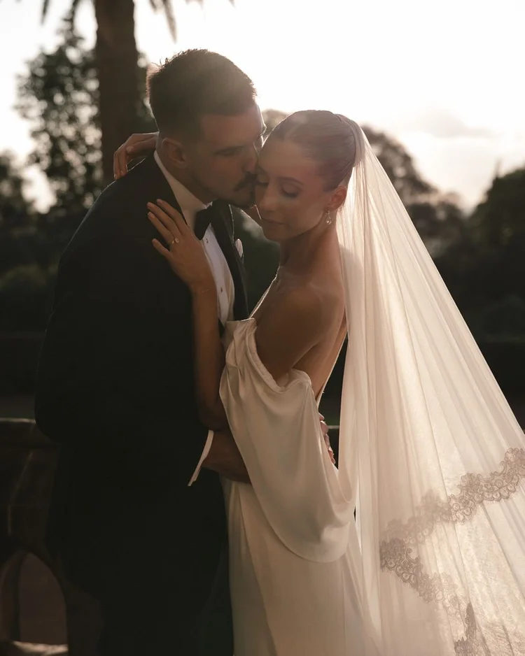 Bride with a lace veil at sunset