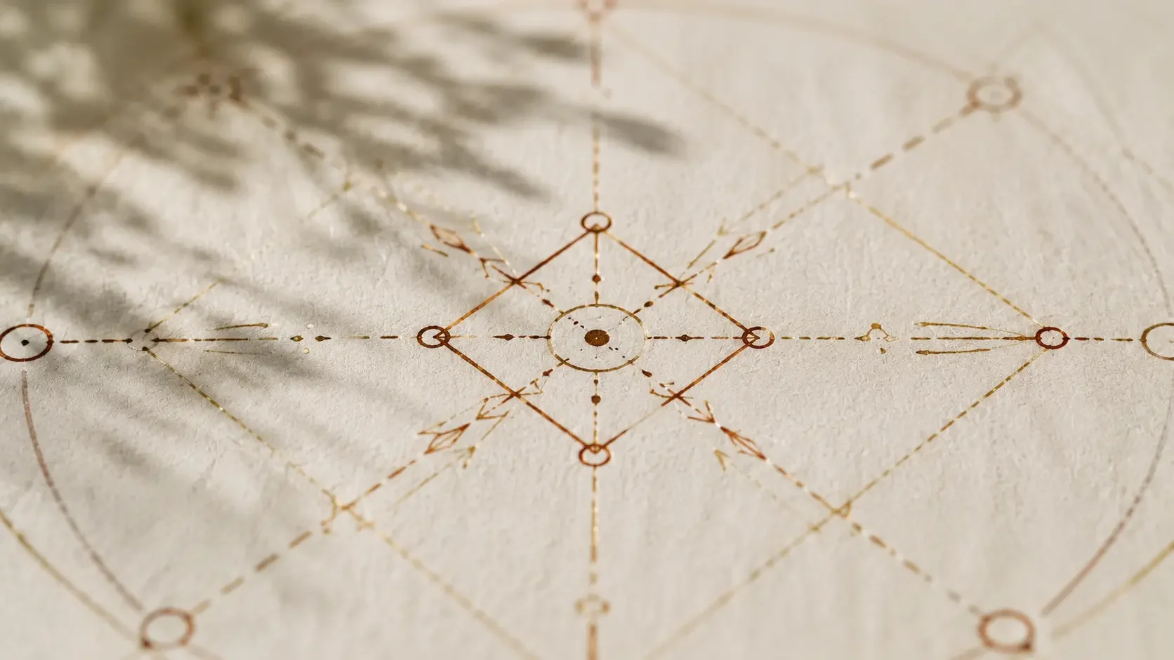 Close detail of a Matrix of Destiny chart's central diamond and connecting lines hand-drawn in terracotta ink on cream paper.