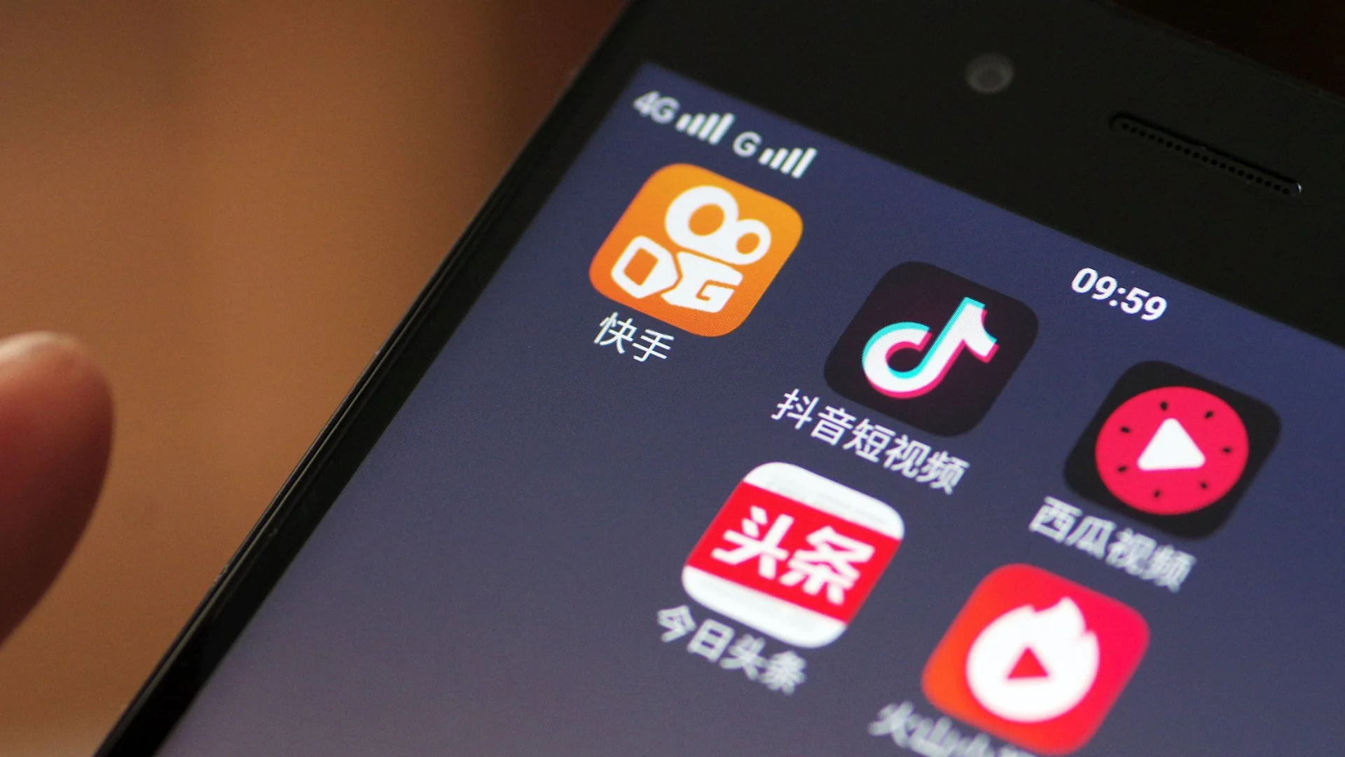 Douyin short video app alongside other Chinese social media apps on a smartphone screen