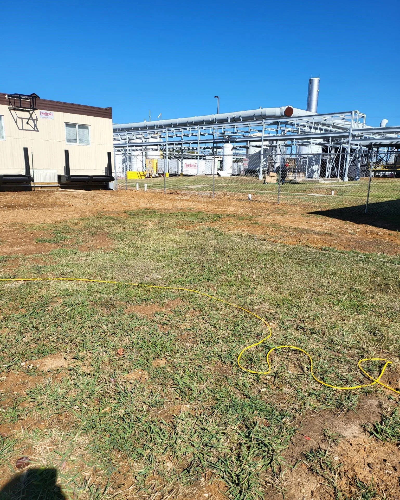 Chain-link perimeter fencing around an industrial facility