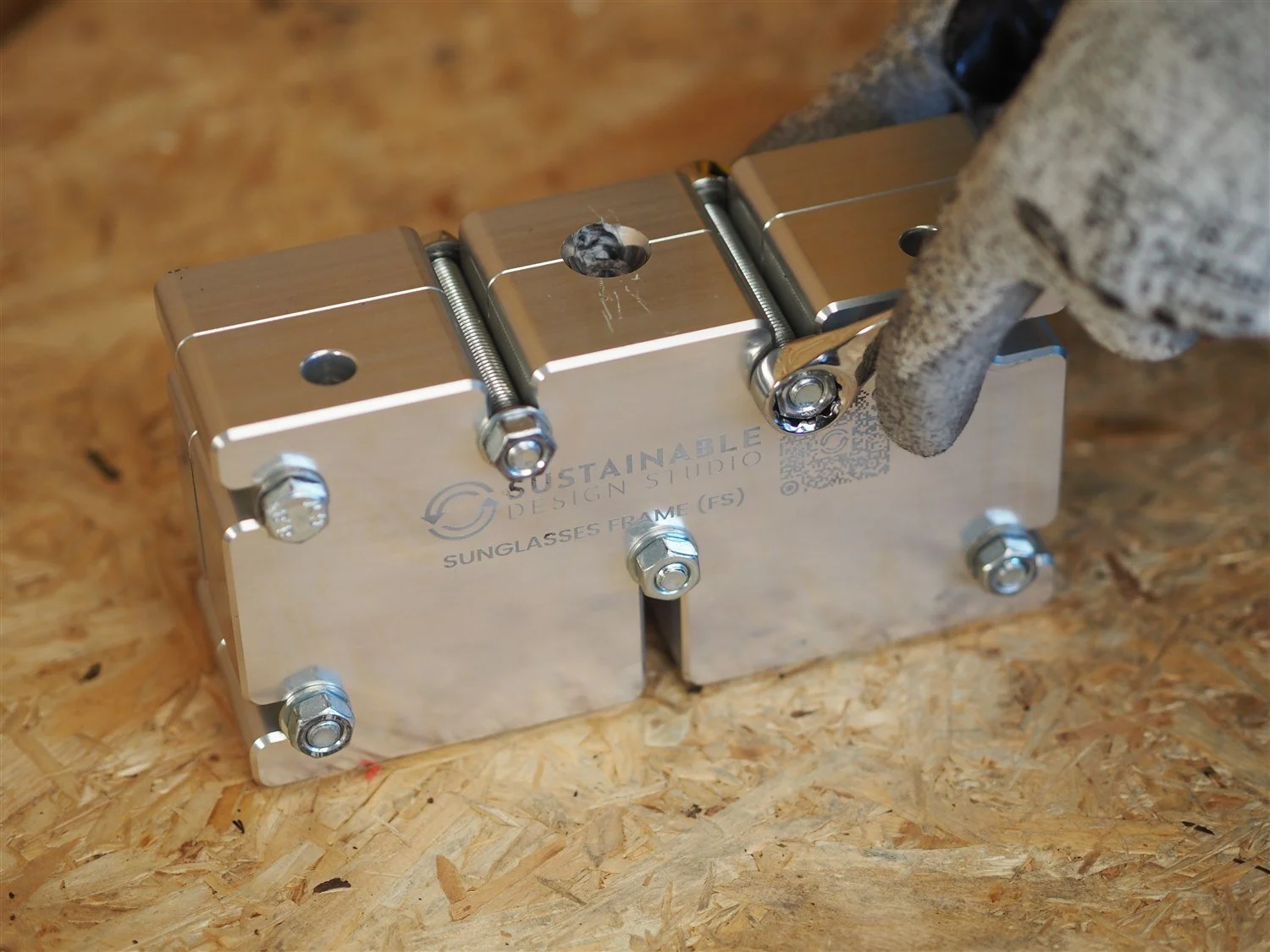 The frame mould closed and bolted, engraved Sunglasses Frame FS, with two locking bolts and flange nuts pulled up tight