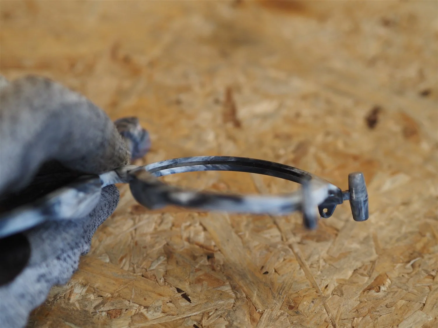 The empty moulded frame held up to the light, both lens channels clear and ready