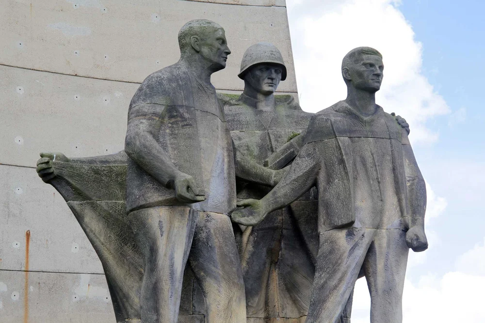 GDR-era sculpture group in front of the obelisk at the Sachsenhausen Memorial