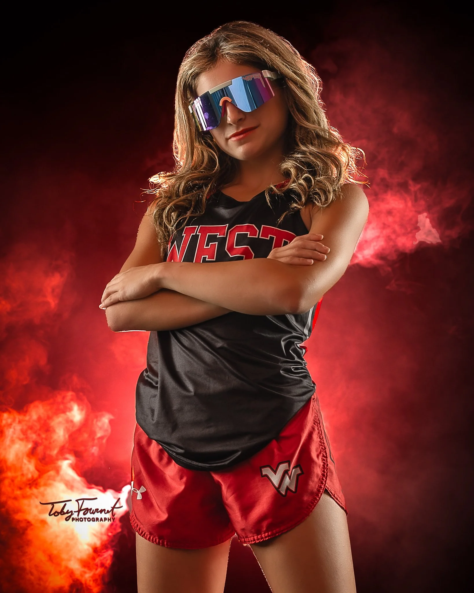 Athlete in sunglasses with red dramatic lighting