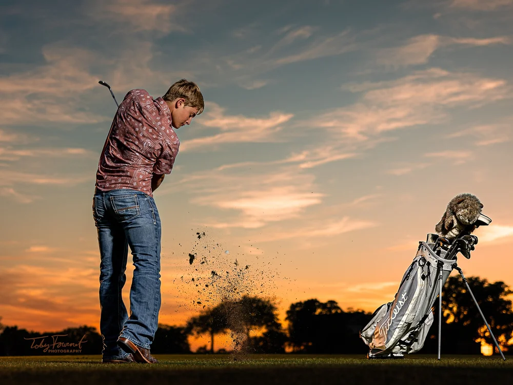Senior golfer swinging at sunset