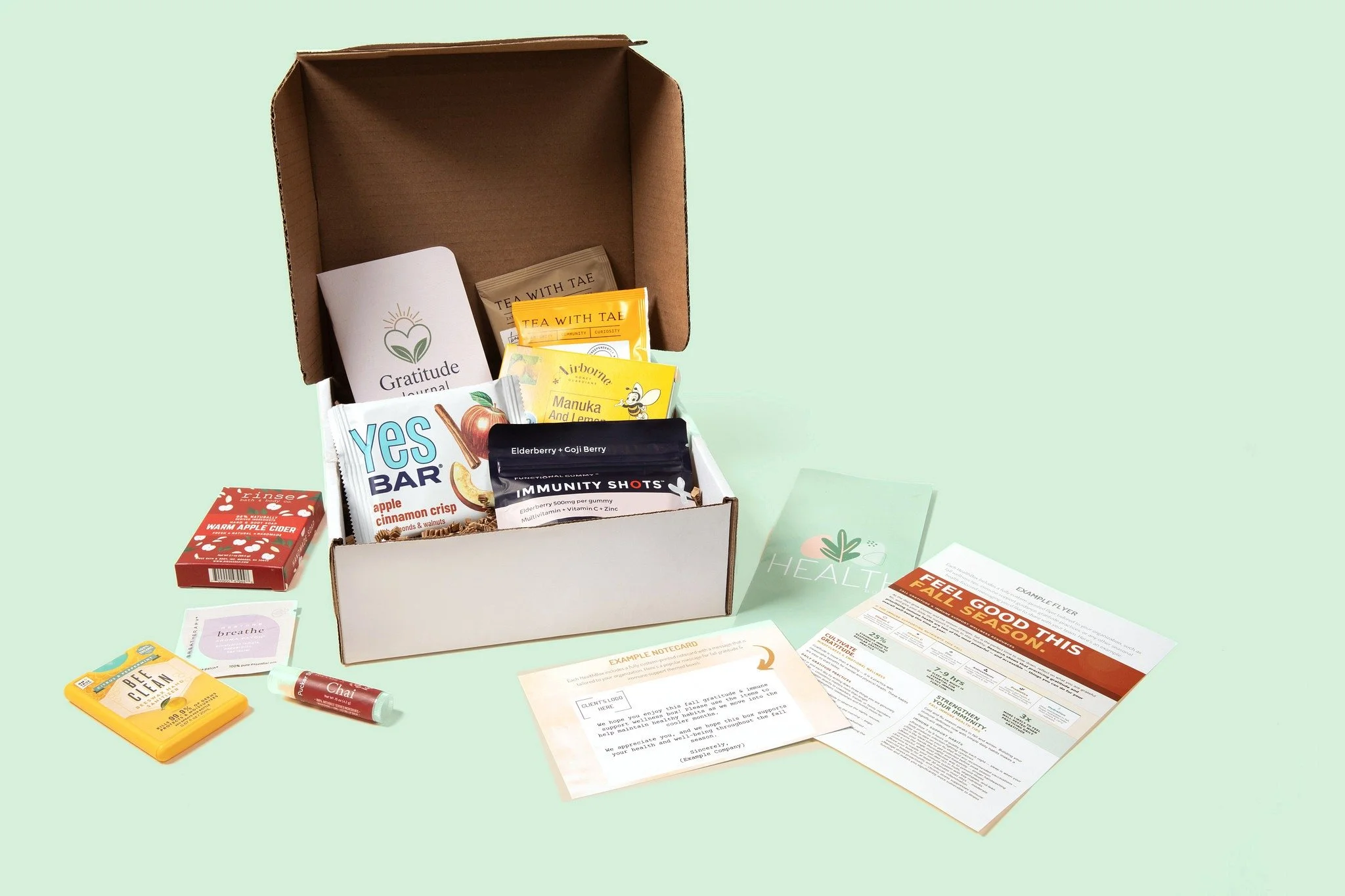 HealthBoxed wellness box shown with a custom printed wellness flyer and a personalized notecard from the employer