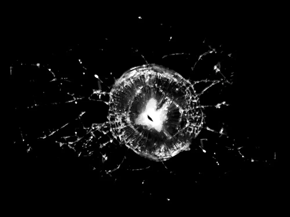 Impact fracture in glass with a ring of cone cracking and radial cracks