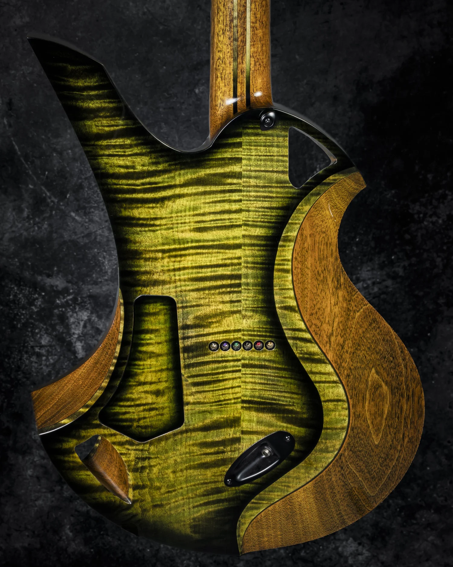 Back of a green Scarab Gatorburst showing two differently shaped openings, carved bevels, and laminated neck