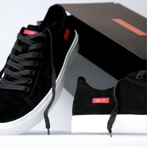 Black suede sneakers on a clean set