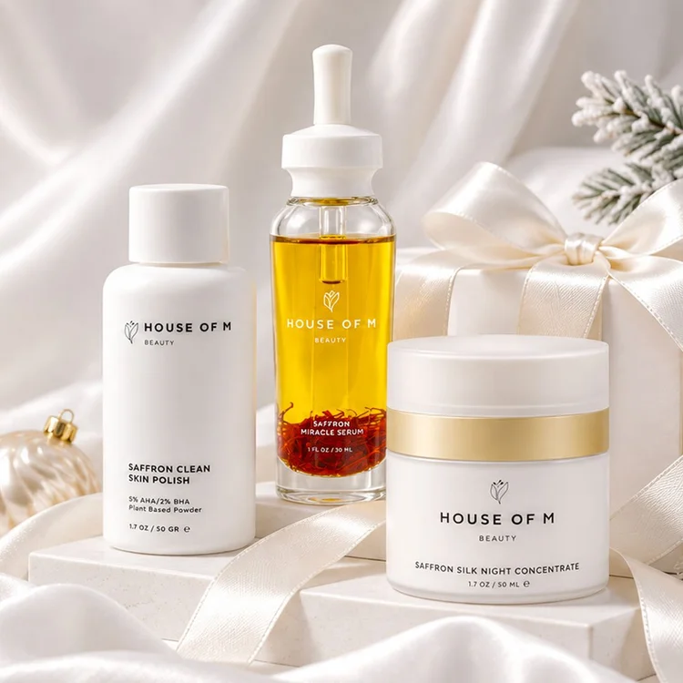 Christmas skincare campaign featuring white beauty products styled with satin ribbon, ornaments and a wrapped holiday gift in soft studio light.
