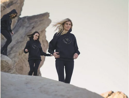 Models in Women of the Galaxy hoodies walking across the rocks at Vasquez Rocks, lifestyle apparel photography