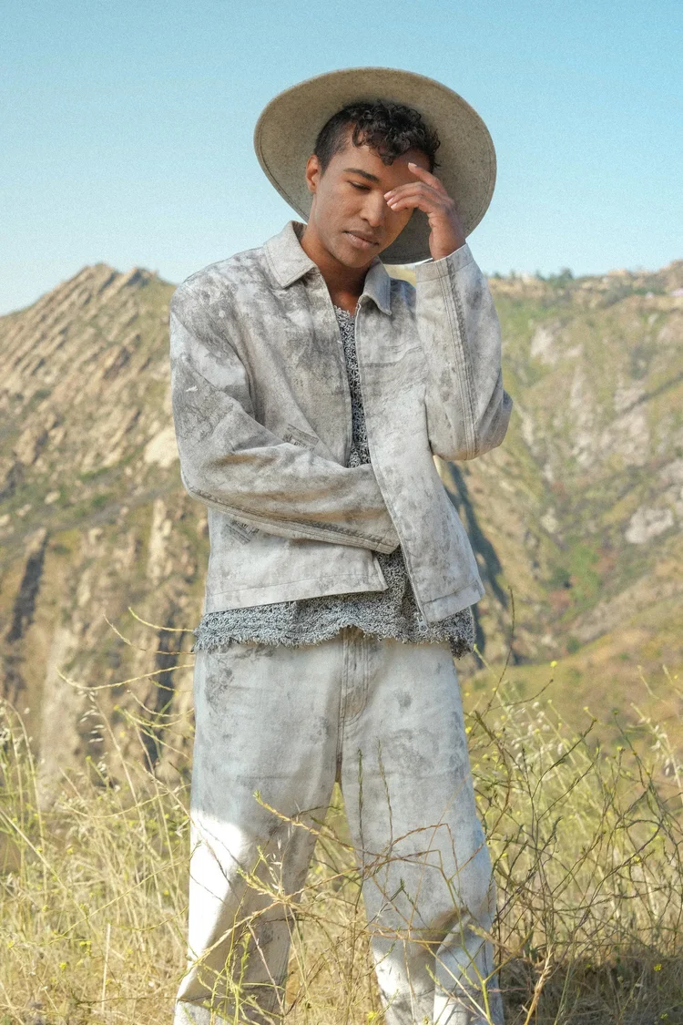 Menswear campaign photography of a model in a wide-brim hat in the Los Angeles hills