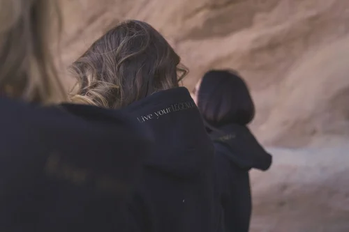 Close-up of the gold Live Your Legend print on a Women of the Galaxy hood, fall apparel detail photography