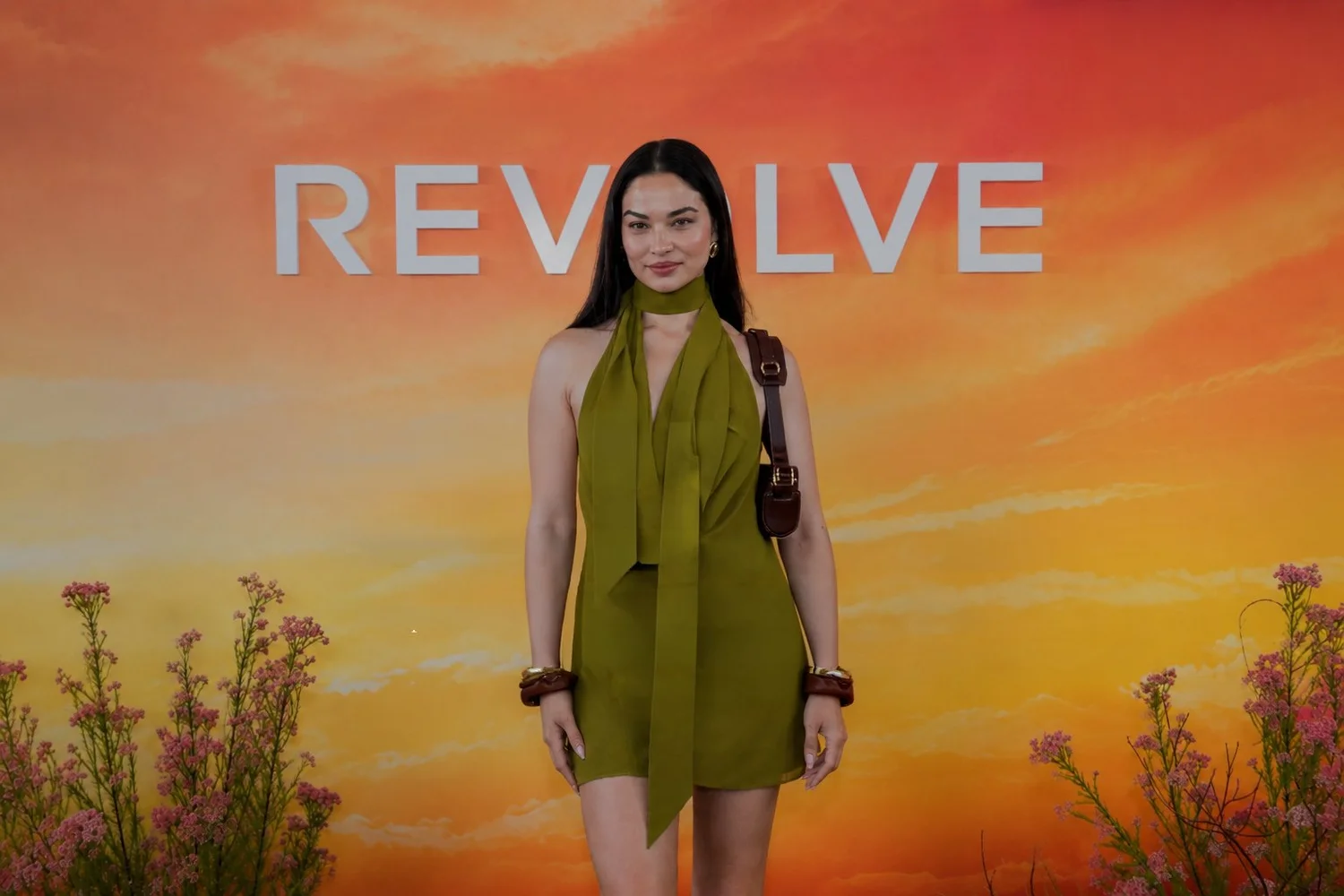 Guest in an olive green dress at the Revolve Festival activation during Coachella, corporate event photography by Chris Frara Studios