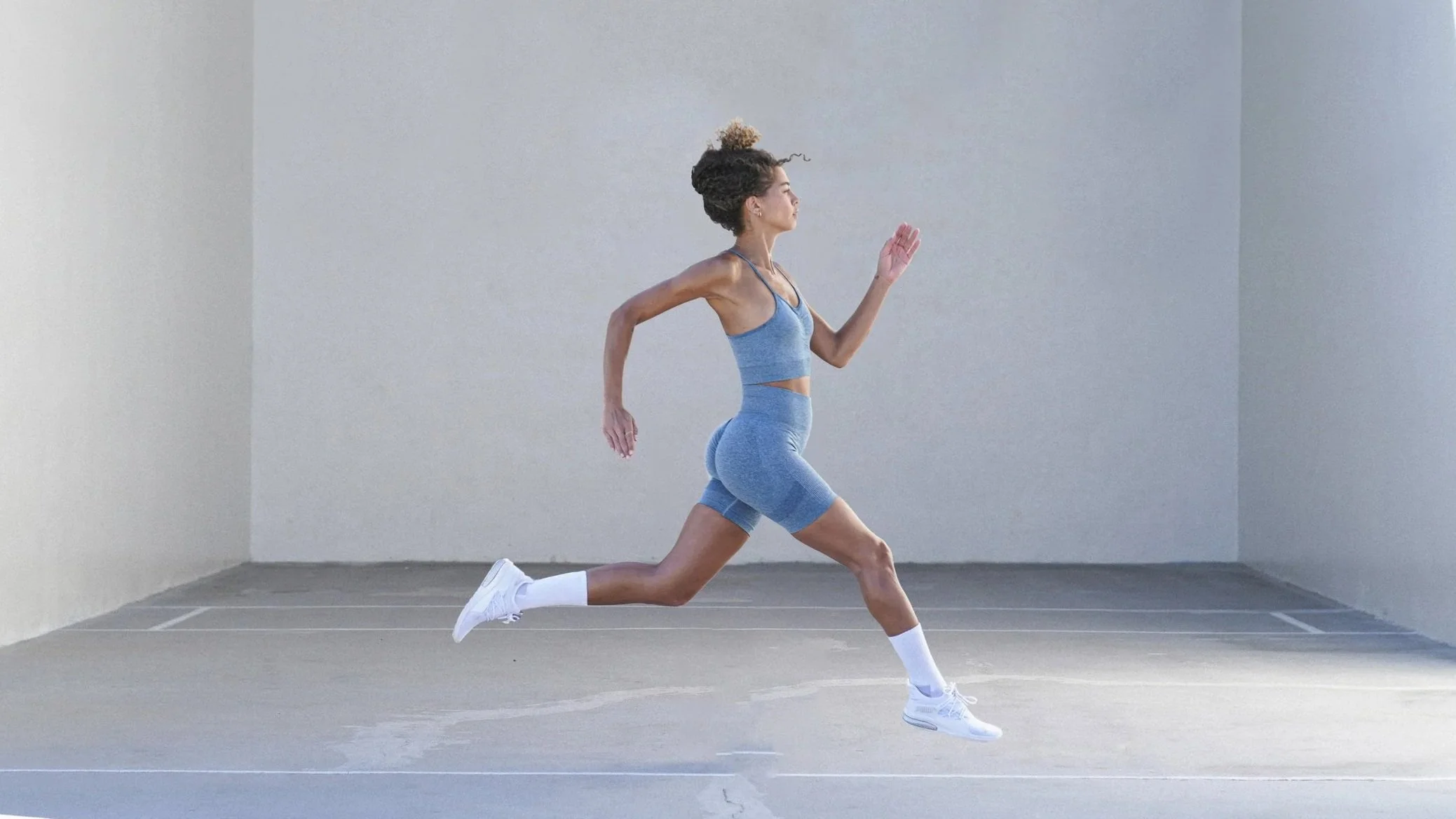 Woman running on Venice Beach in Puma athletic wear, commercial fitness and sportswear campaign photography, Los Angeles