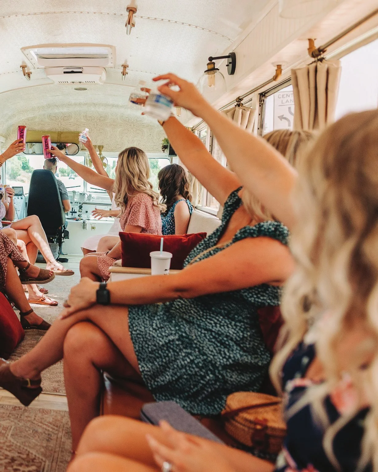 Friends raising their glasses together inside a Toasted Tours vehicle