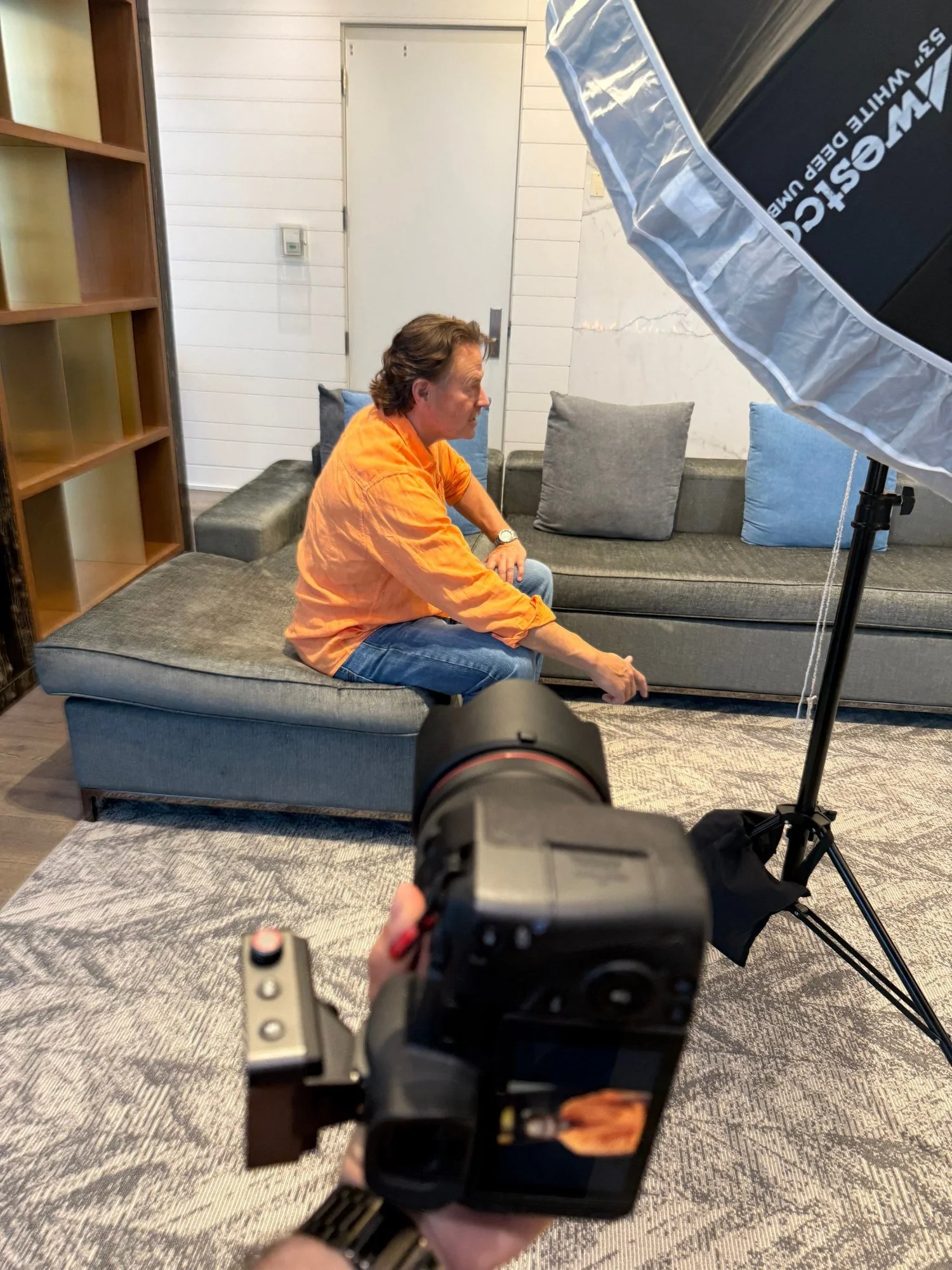 On-location headshot session at Merchants' Wharf, Toronto: Stewart Kiff seated in the lounge with a Westcott umbrella light beside him
