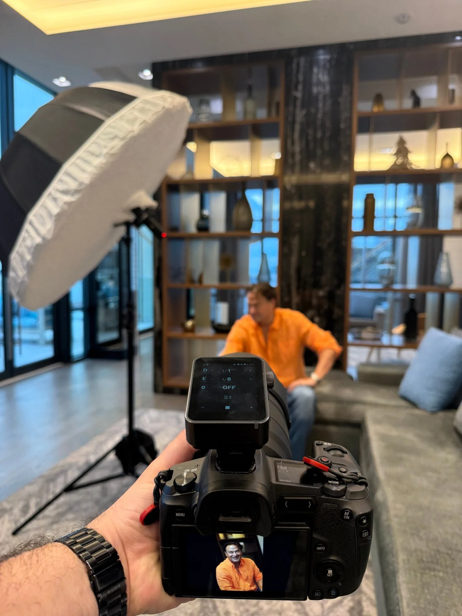 Behind the scenes of an on-location headshot session at Merchants' Wharf, Toronto: Ymaphoto photographing Stewart Kiff with a portable studio light