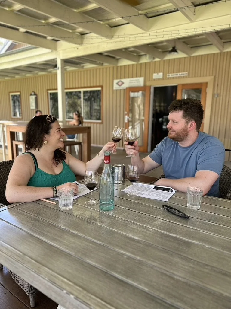 Two guests raising their wine glasses during a Hunter Valley wine tasting