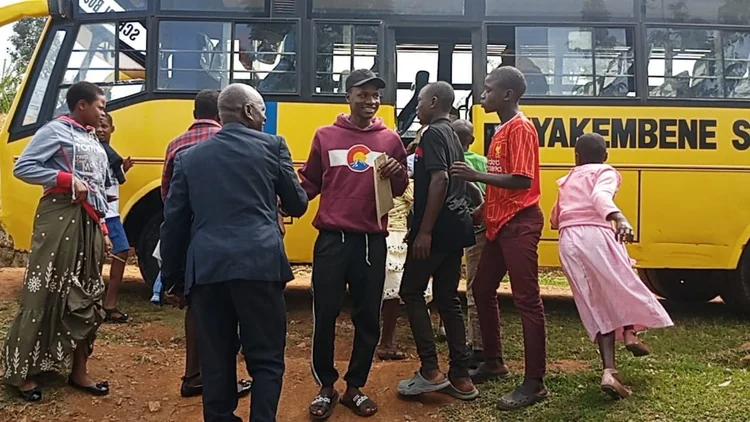 Members of the Kisii community gathered beside a bus