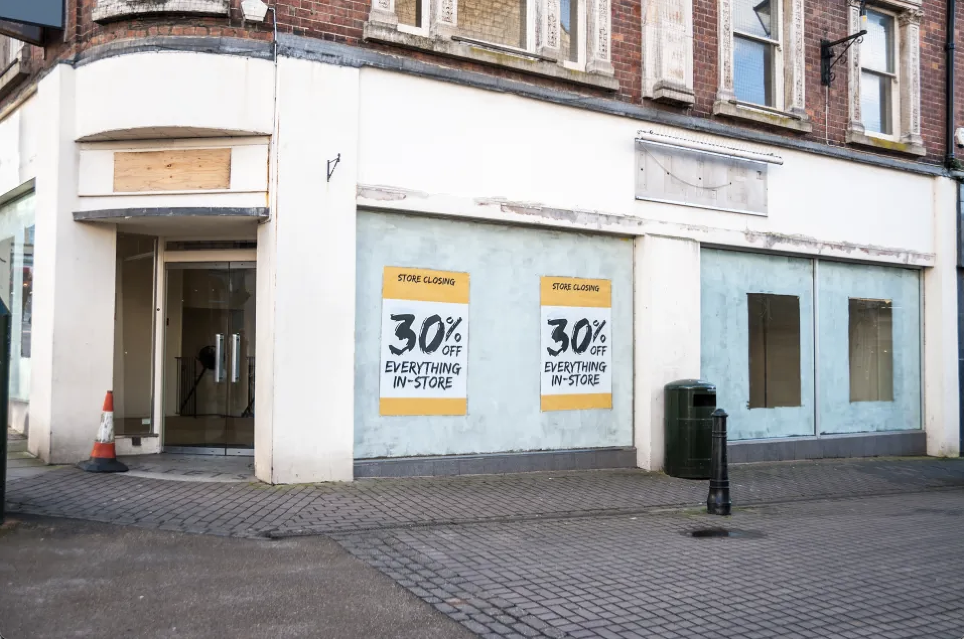 Shuttered high street with bare shelves