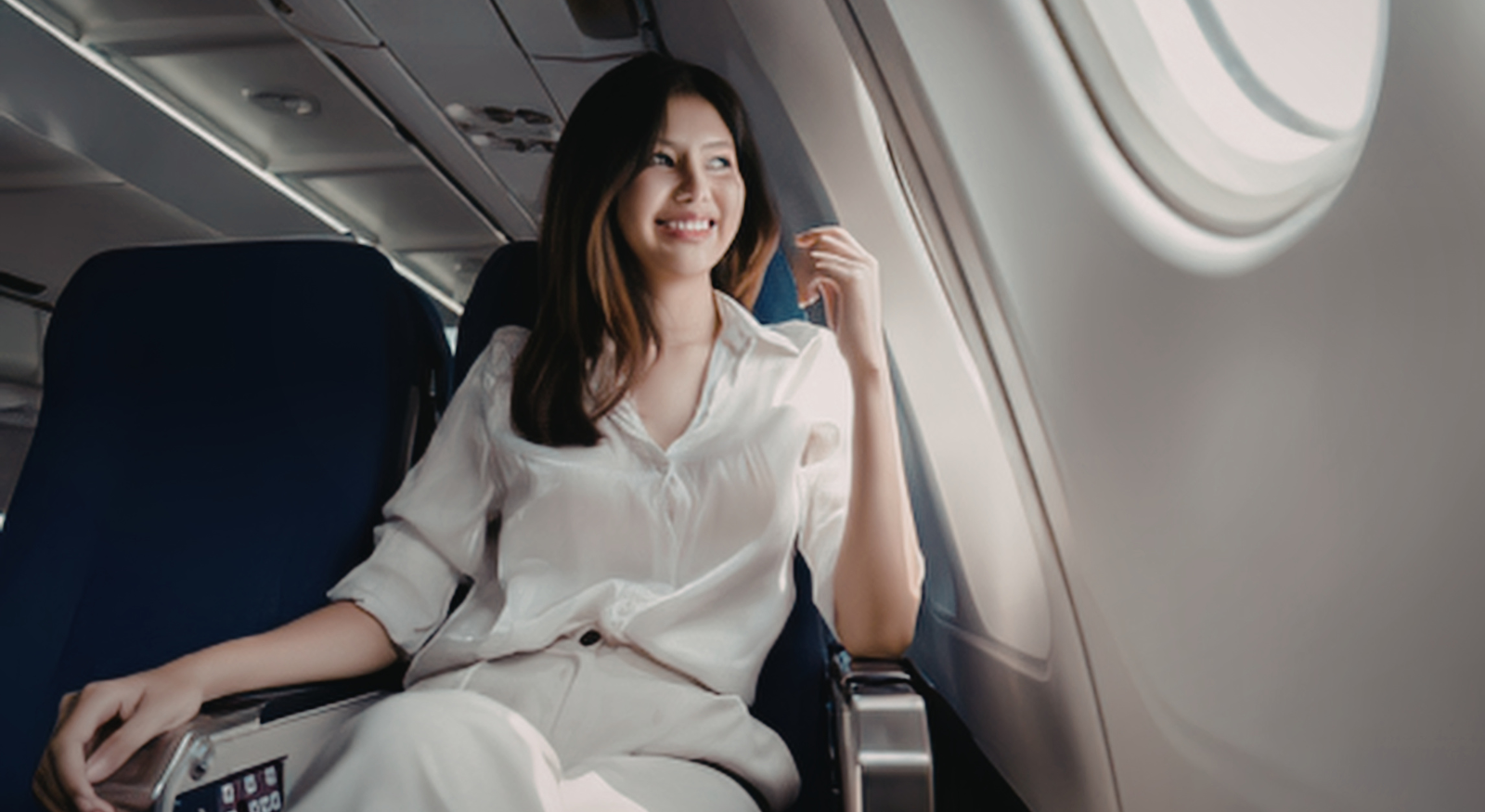 Woman sitting calmly on a plane after fear of flying hypnotherapy Sydney