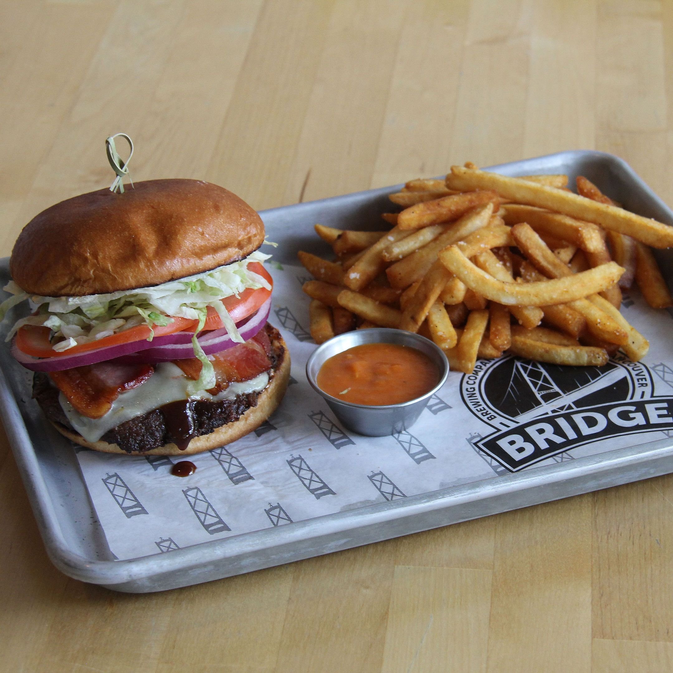 The Decked Out Burger with deck fries and sauce on a Bridge tray.