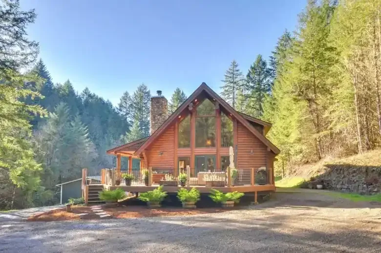 The log cabin at Fernlove, viewed from the front, with floor-to-ceiling windows