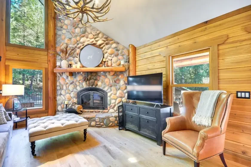 The living room, by the river-stone fireplace