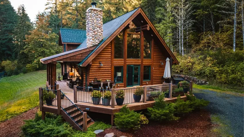 The main house, a log cabin set in the Oregon forest