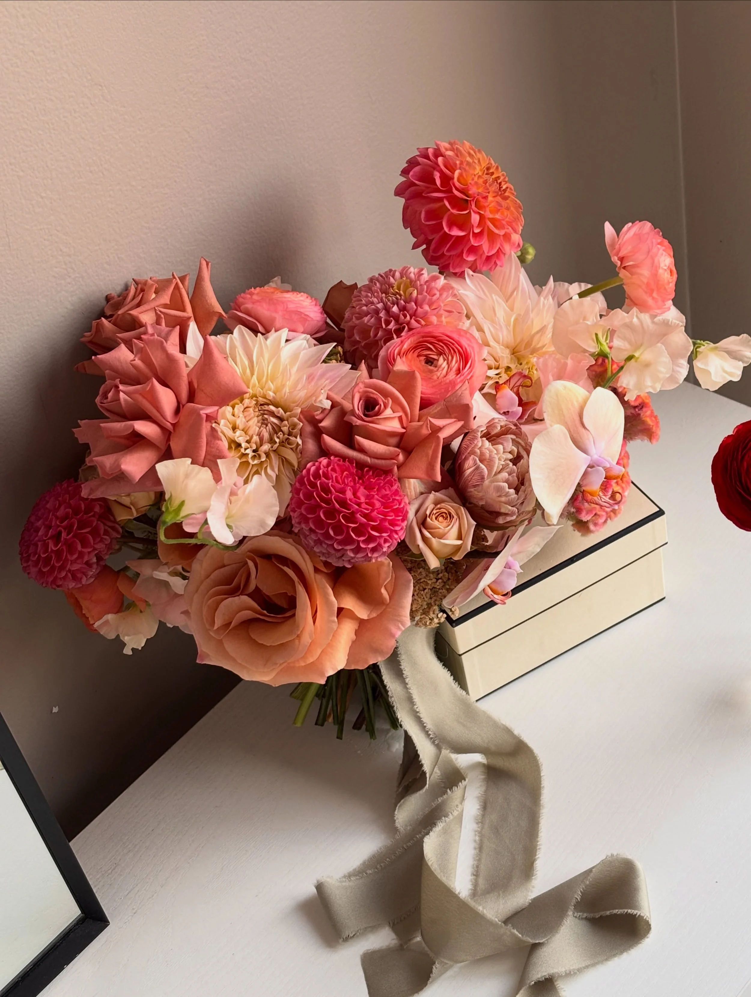 Erin’s bridal bouquet in peach, rose and coral tones, with dahlias, roses and orchids