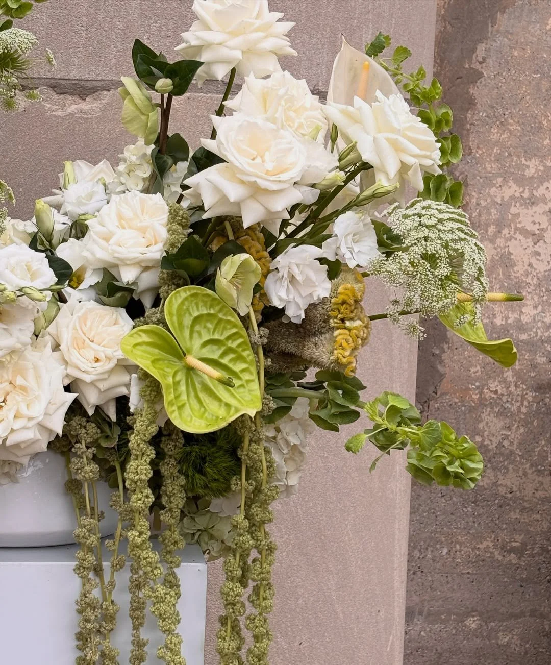 Close view of the layered white and green floral composition