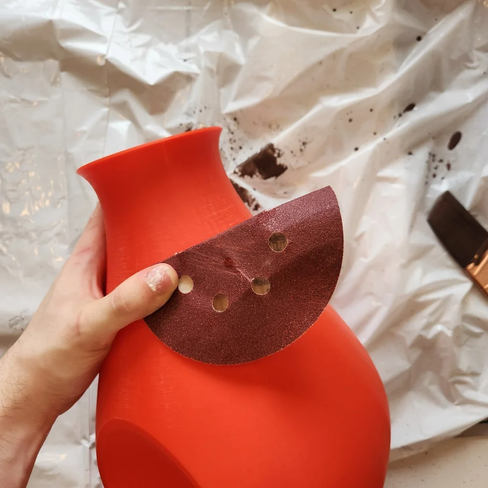 Sanding the red pot
