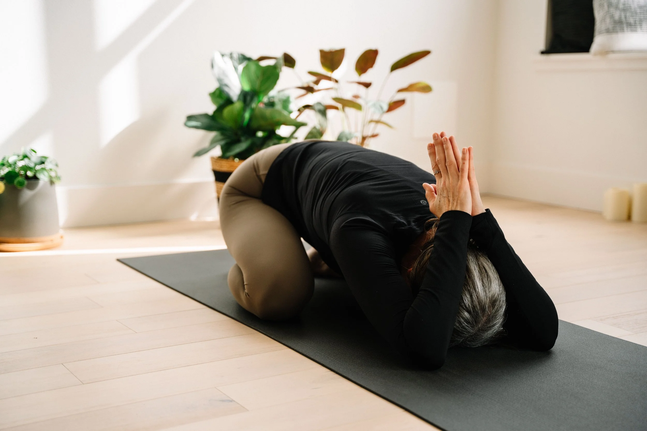 Student resting in child's pose