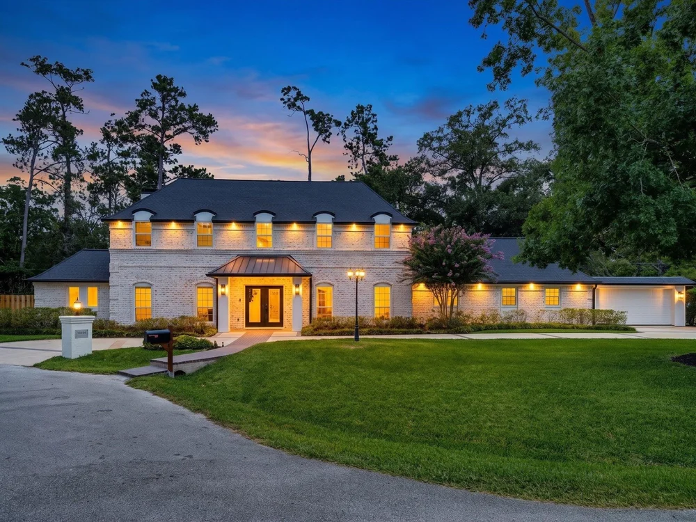 Twilight exterior of 11831 Balmoral Lane in Bunker Hill Village, one of Houston’s Memorial Villages