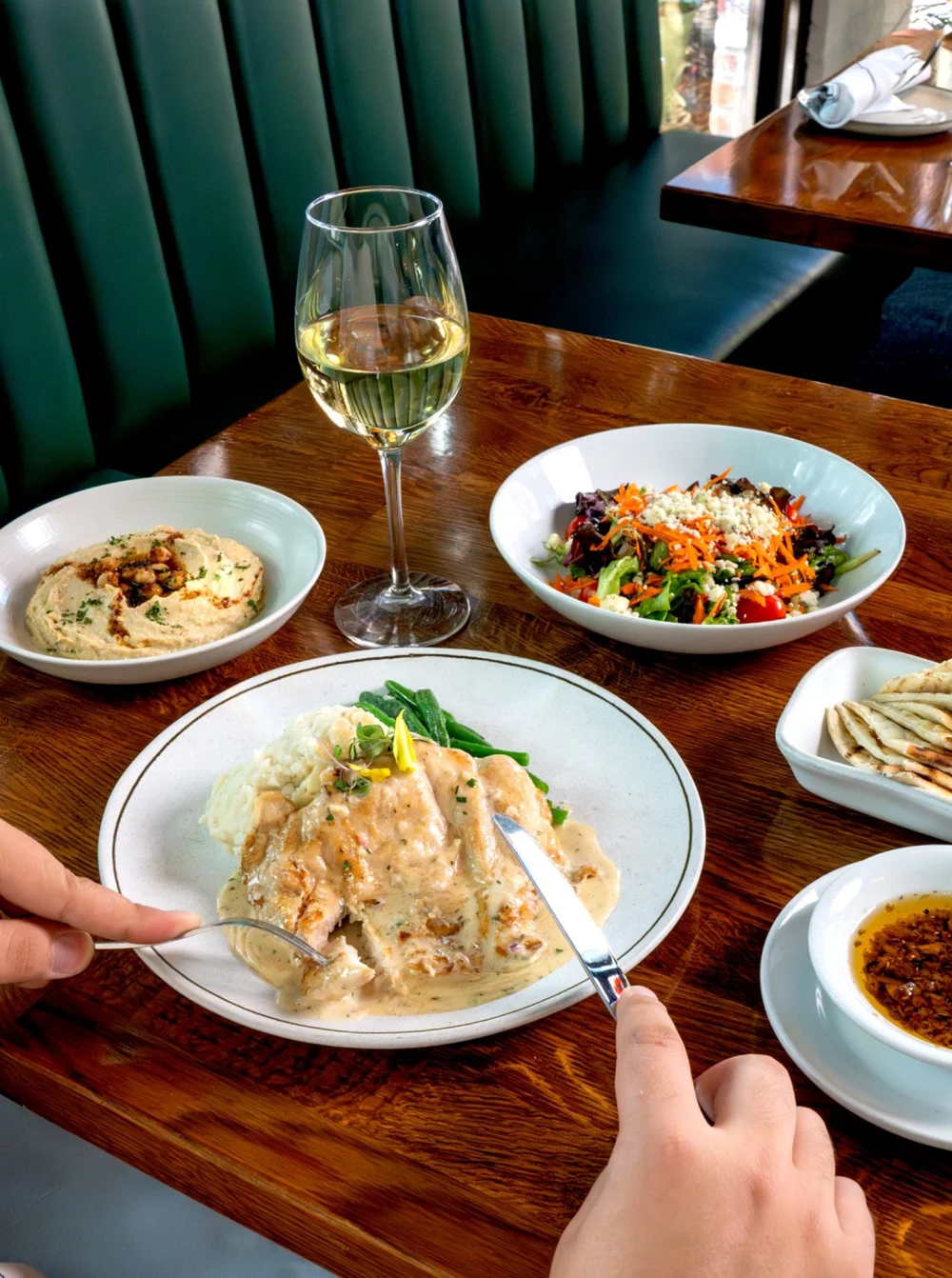 A Mediterranean meal with hummus, salad, fish and wine at Lokanta