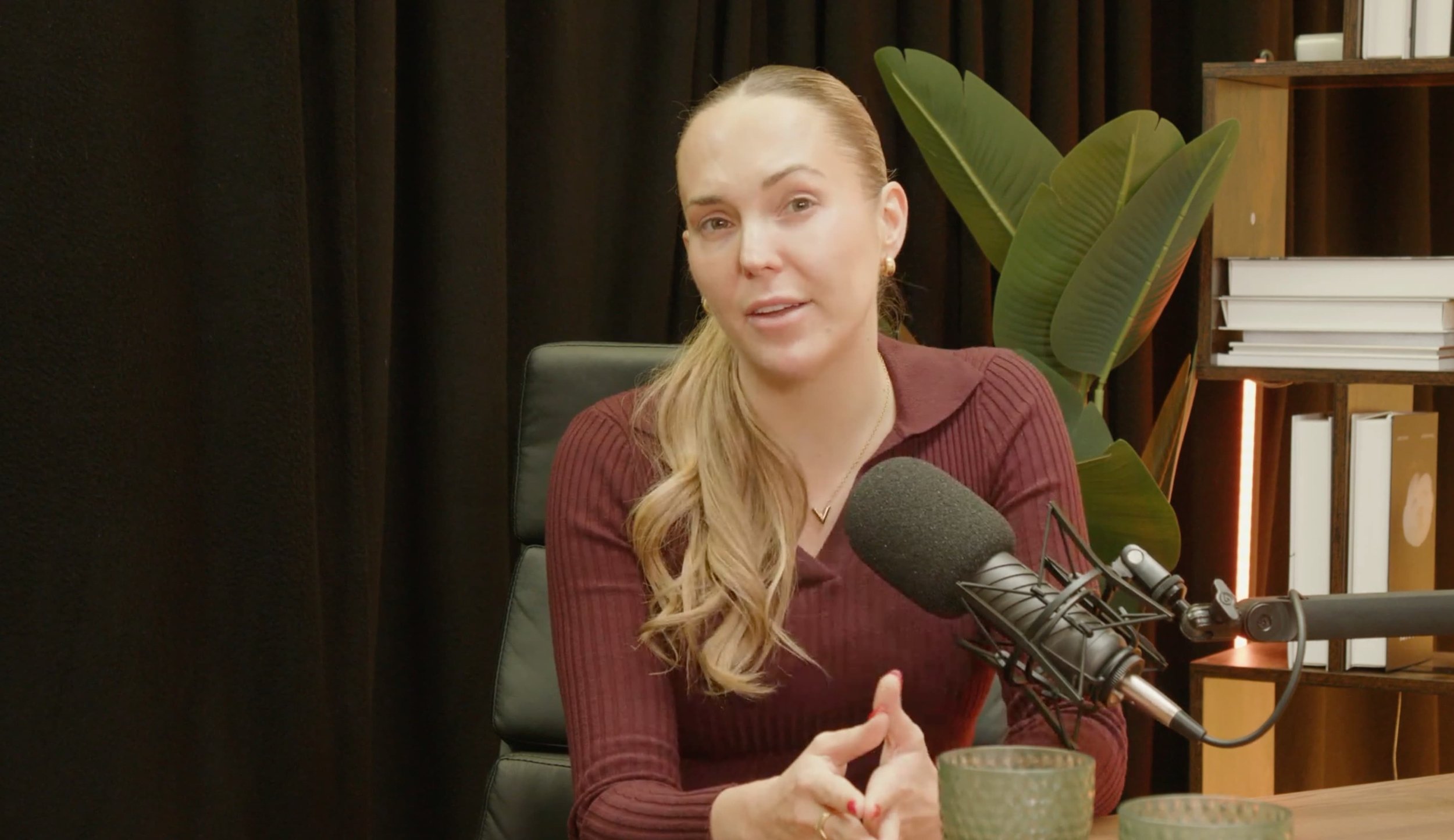 Female podcast guest speaking into a microphone